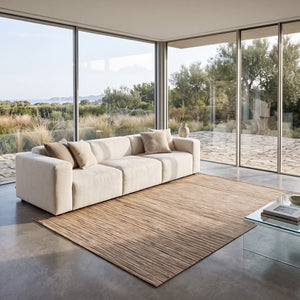 Acsento Origin Beige rug in beige with fine sand and caramel stripes, shown in an interior