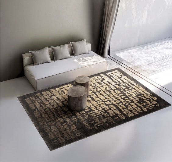 Acsento Papyrus Brown rug in dark brown with rows of golden brush marks, shown in an interior