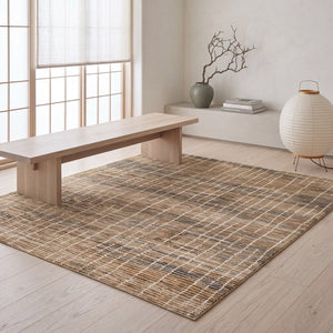 Acsento Siena 68 rug in beige with a soft check in sand, ochre and charcoal, shown in an interior