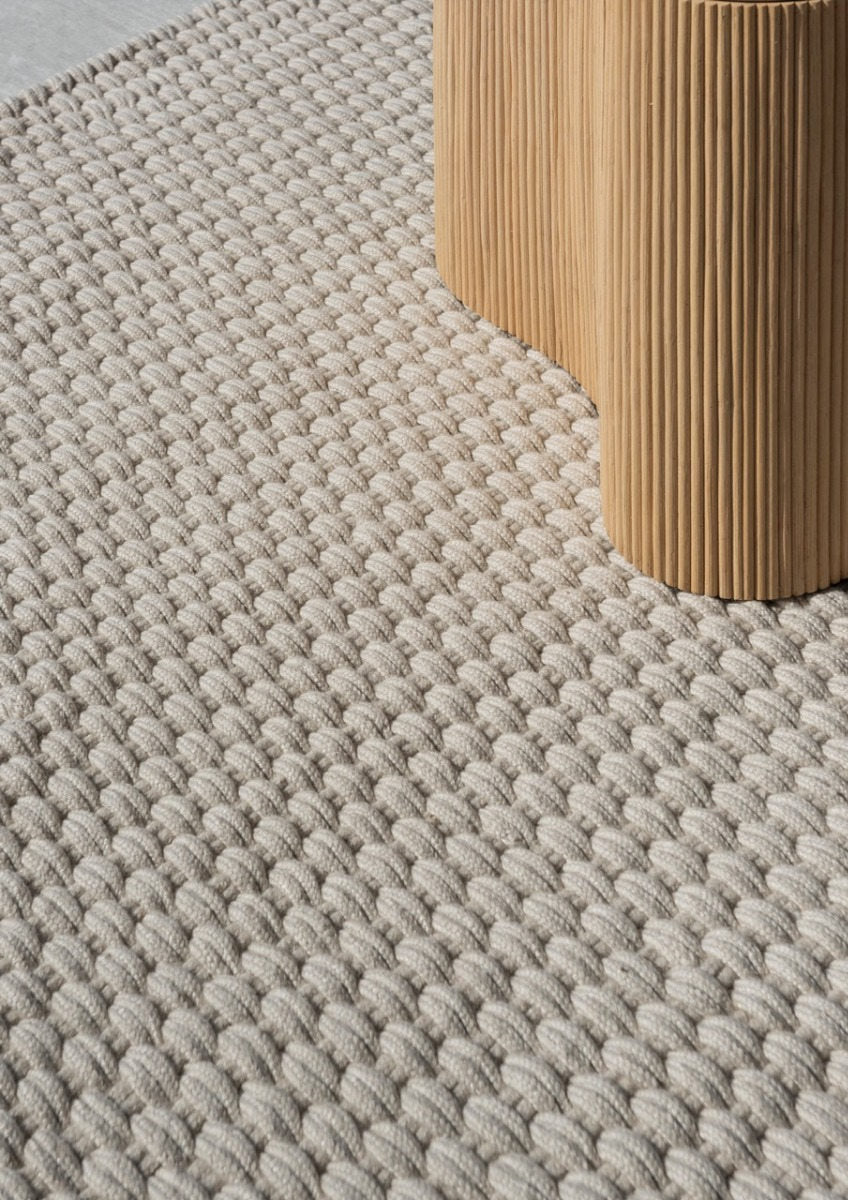 Close-up of white and sand flatweave texture made from recycled PET fibres