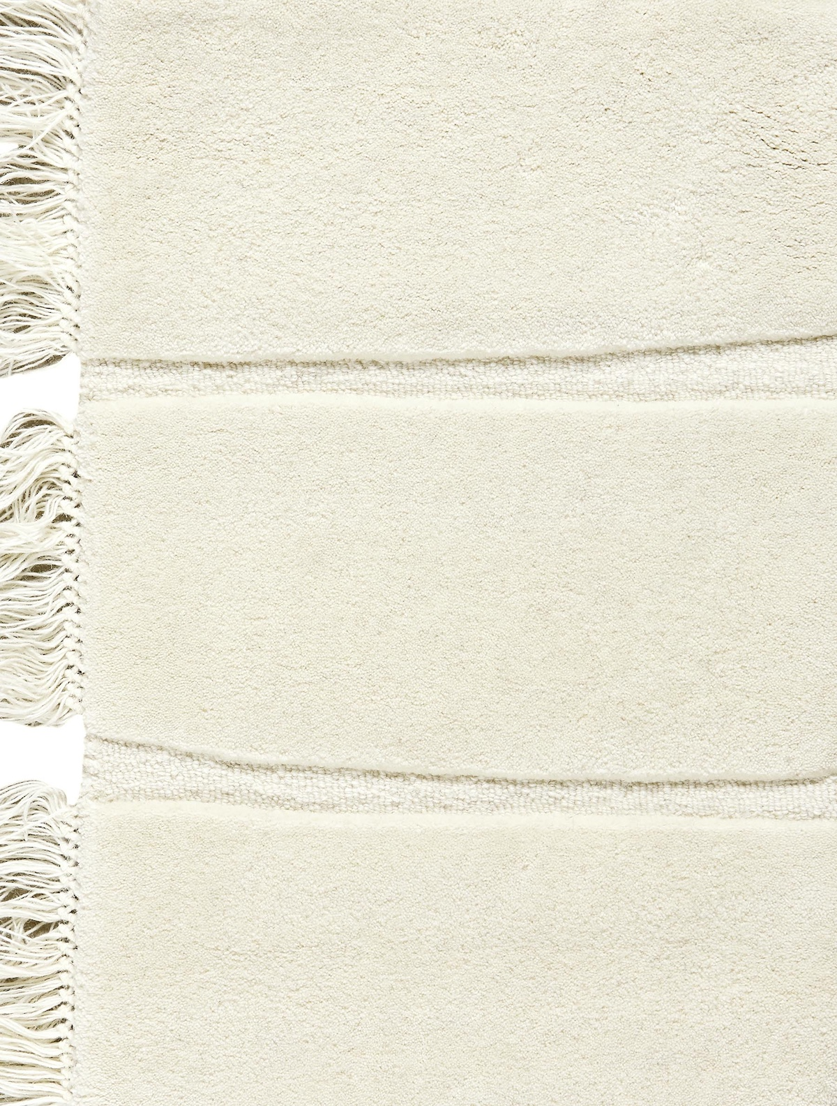 Massimo Atoll Cream hand tufted wool rug, detail of the fringes