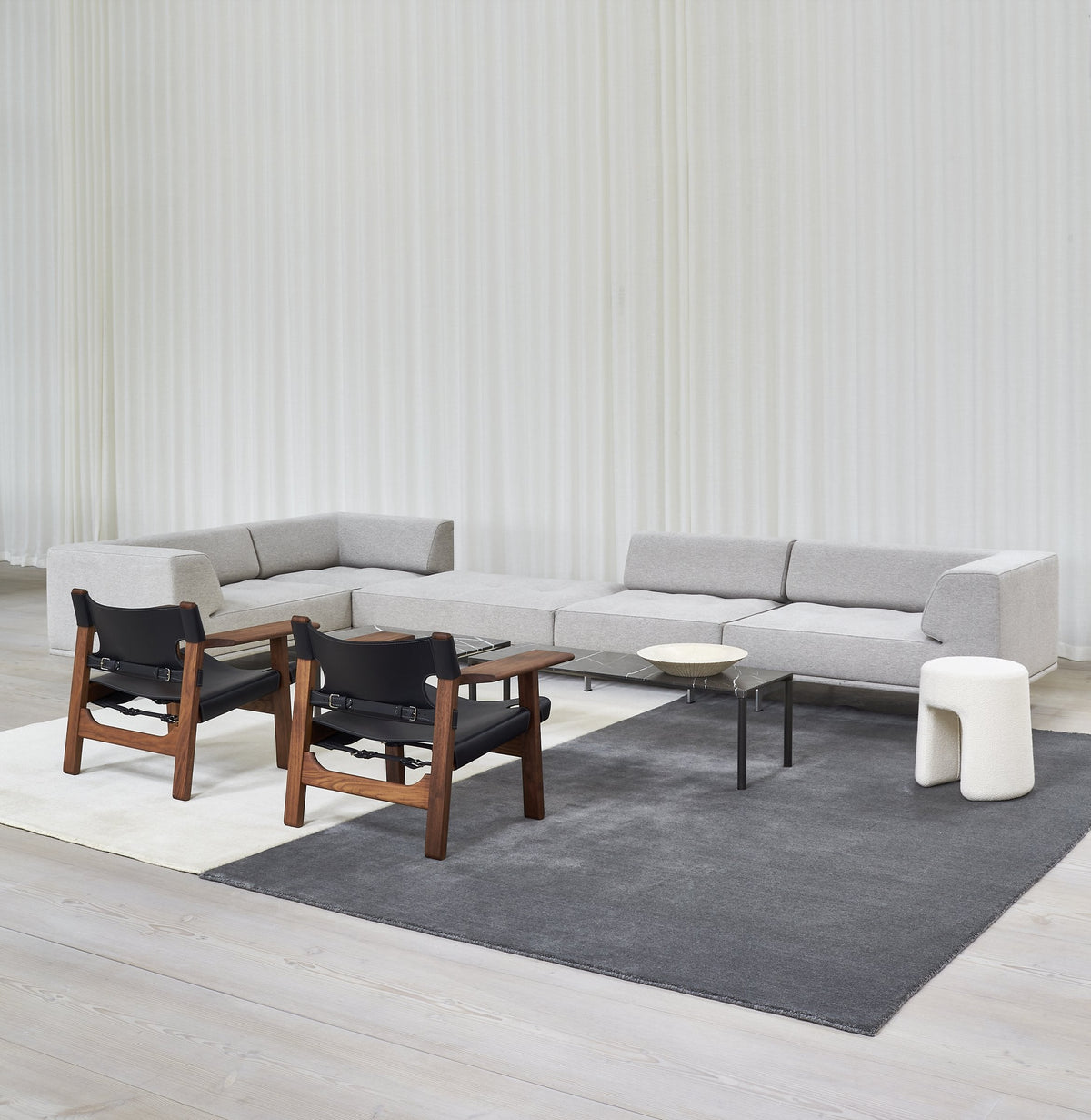 Massimo Earth Natural Dark Grey wool rug, styled in a bright room