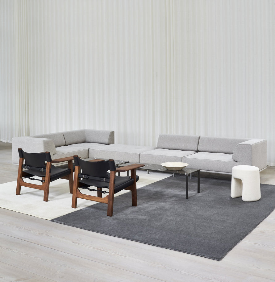 Massimo Earth Natural Dark Grey wool rug, styled in a bright room