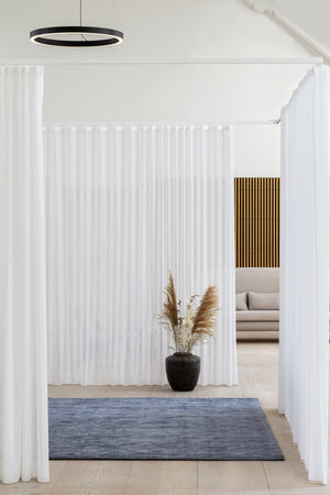 Massimo Karma Washed Blue bamboo silk rug, shown in an interior