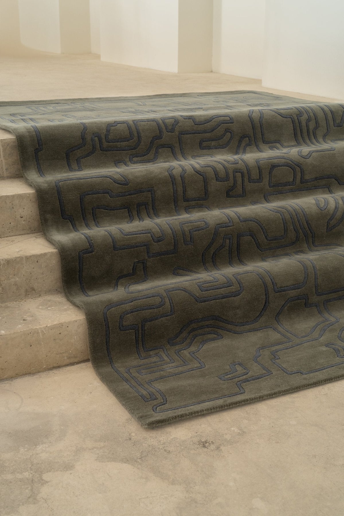 Massimo Structures 2.0 Arctic Green rug, draped over a flight of steps