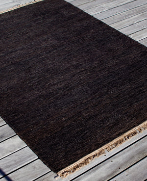 Massimo Sumace Black jute rug with fringes, perspective view