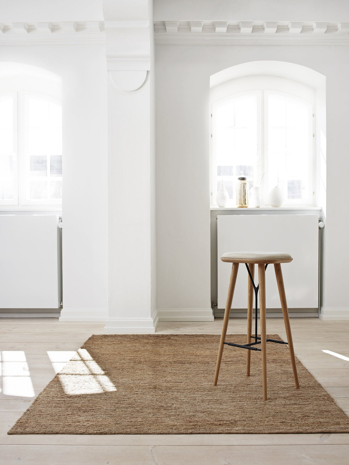 Massimo Sumace Natural fringed jute rug, shown in an interior